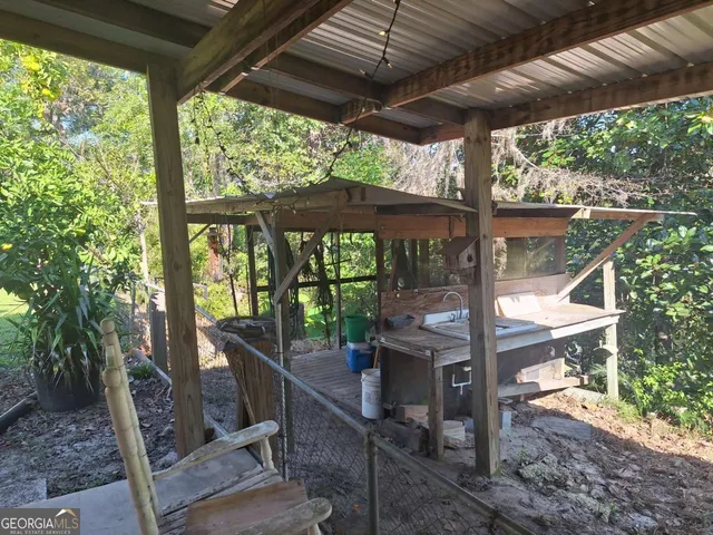 a view of backyard with green space and seating
