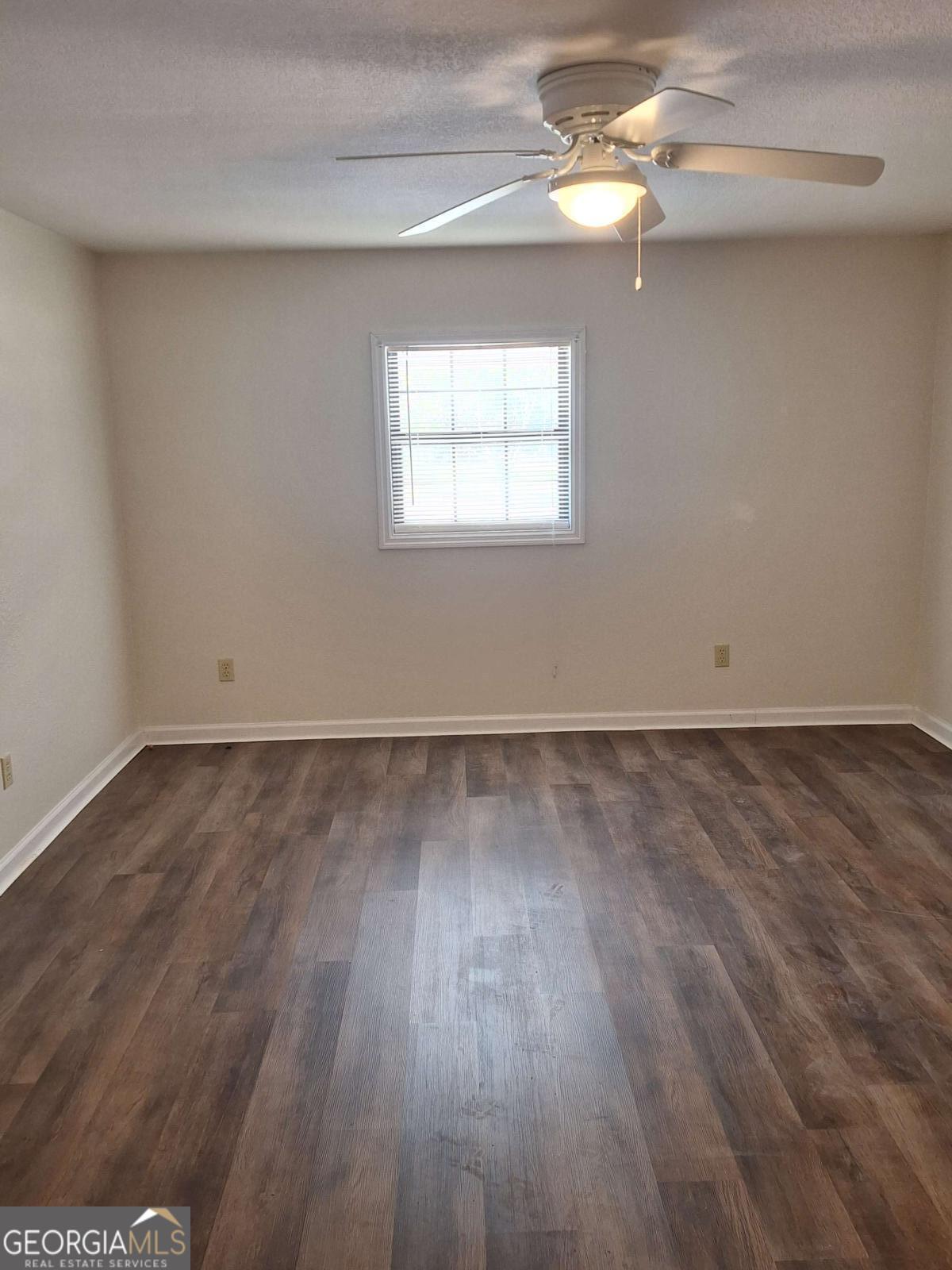 163 High Bluff Road Baxley, GA 31513 - Photo 7 of 52 wooden floor in an empty room with a window