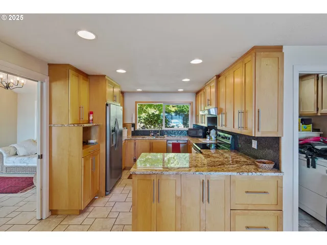 a kitchen with refrigerator cabinets and furniture