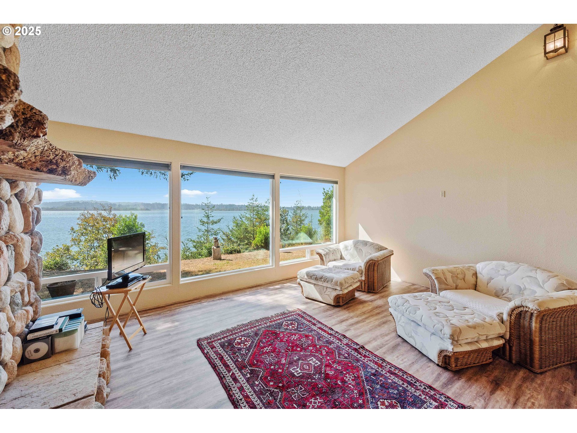 64662 East Bay Road North Bend, OR 97459 - Photo 24 of 48 a living room with furniture and a large window