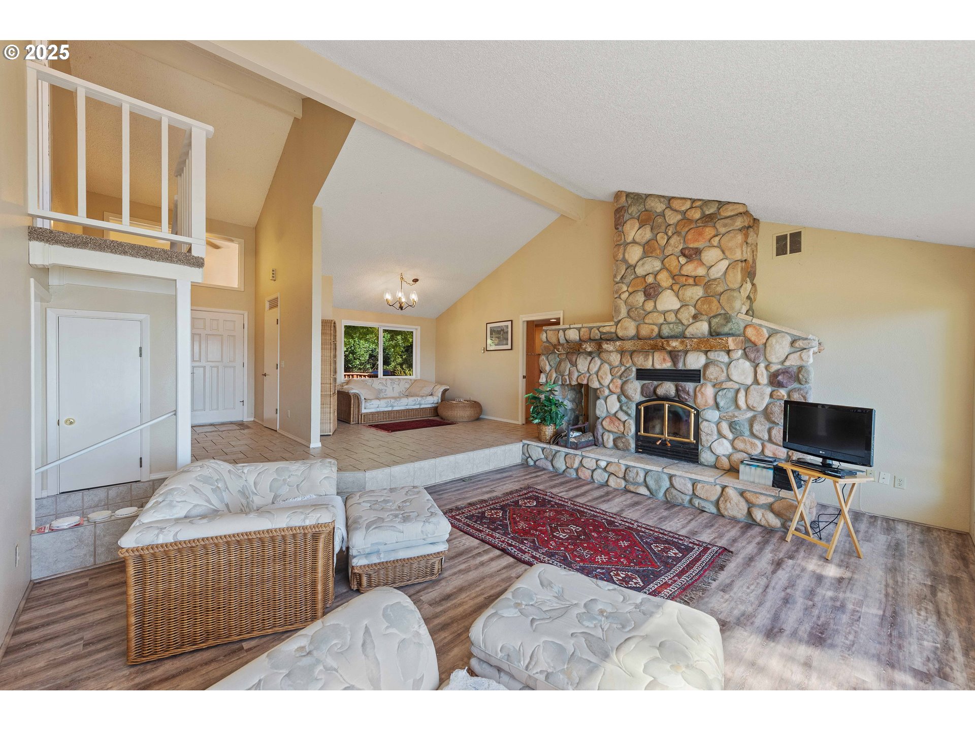 64662 East Bay Road North Bend, OR 97459 - Photo 27 of 48 a living room with furniture and a fireplace