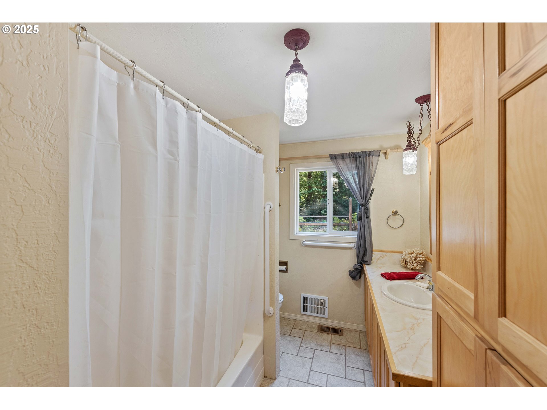 64662 East Bay Road North Bend, OR 97459 - Photo 32 of 48 a bathroom with a sink a mirror and a shower