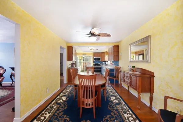 a view of a dining room with furniture window and wooden floor
