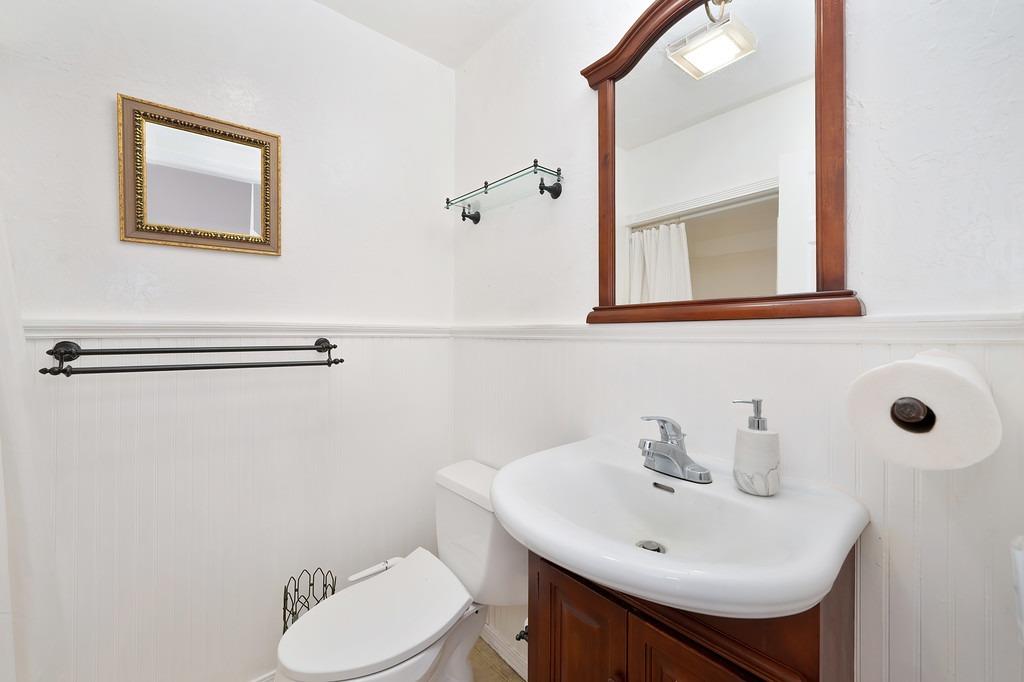 6930 Loggers Hollow Road Somerset, CA 95684 - Photo 16 of 42 a bathroom with a sink mirror and toilet