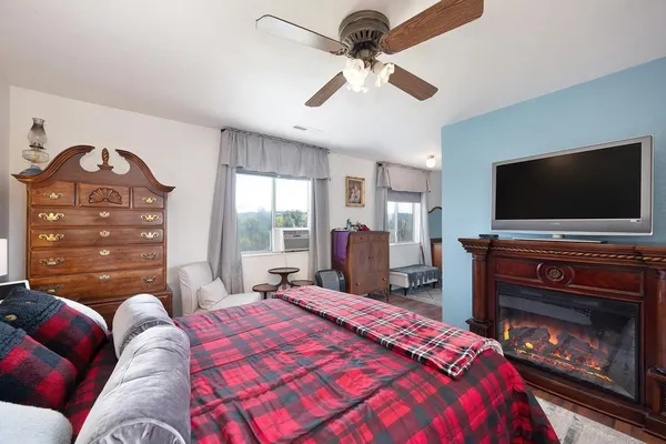 a bedroom with a bed and a flat screen tv