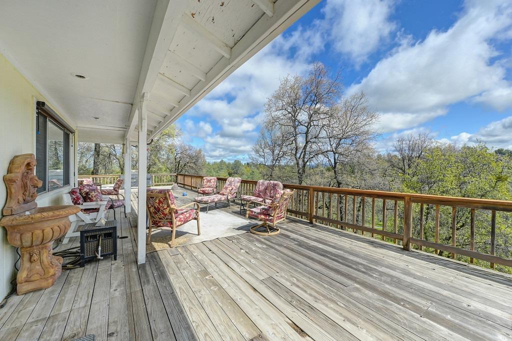 6930 Loggers Hollow Road Somerset, CA 95684 - Photo 2 of 42 a view of a balcony with chairs and wooden floor