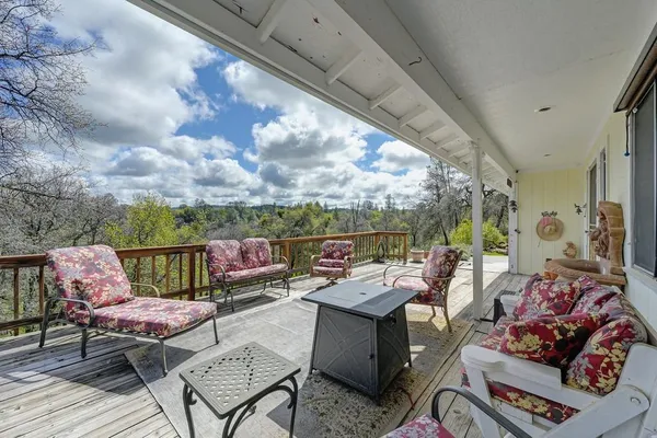 a view of a roof deck with furniture