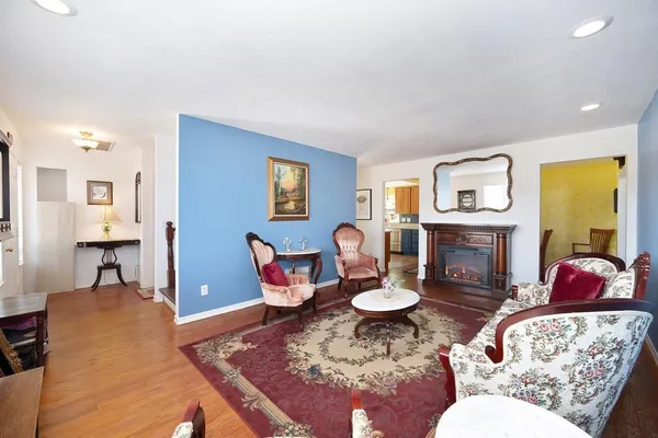 a living room with furniture a fireplace and a table
