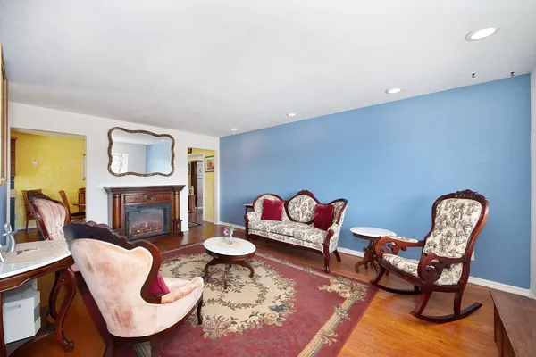 a living room with furniture a rug and a fireplace