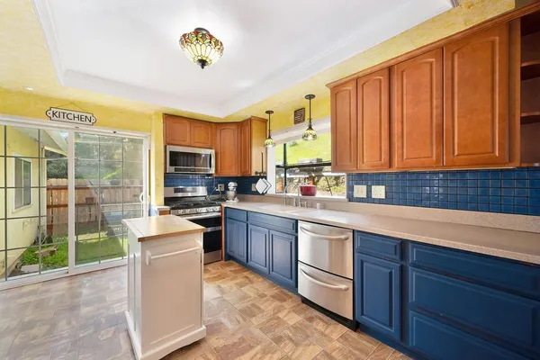 a kitchen with sink cabinets and appliances