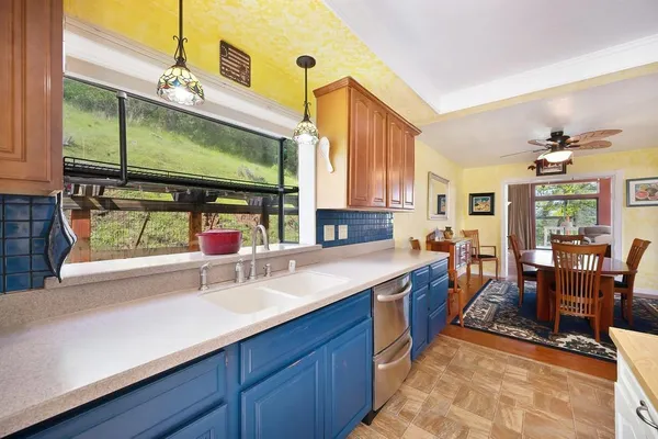 a kitchen with stainless steel appliances granite countertop sink stove and cabinets