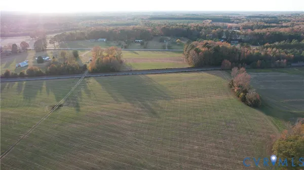 a view of a field with trees in the background
