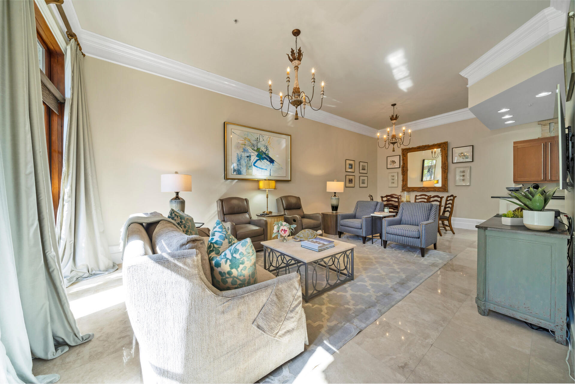 9201 Market Street Inn, Unit 162 Miramar Beach, FL 32550 - Photo 15 of 67 a living room with furniture a chandelier and a dining table