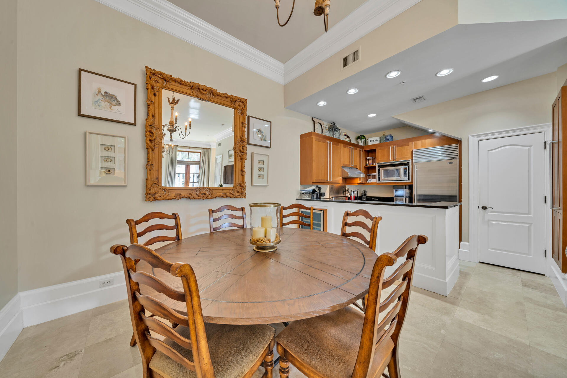 9201 Market Street Inn, Unit 162 Miramar Beach, FL 32550 - Photo 21 of 67 a kitchen with stainless steel appliances kitchen island granite countertop a table chairs and a refrigerator