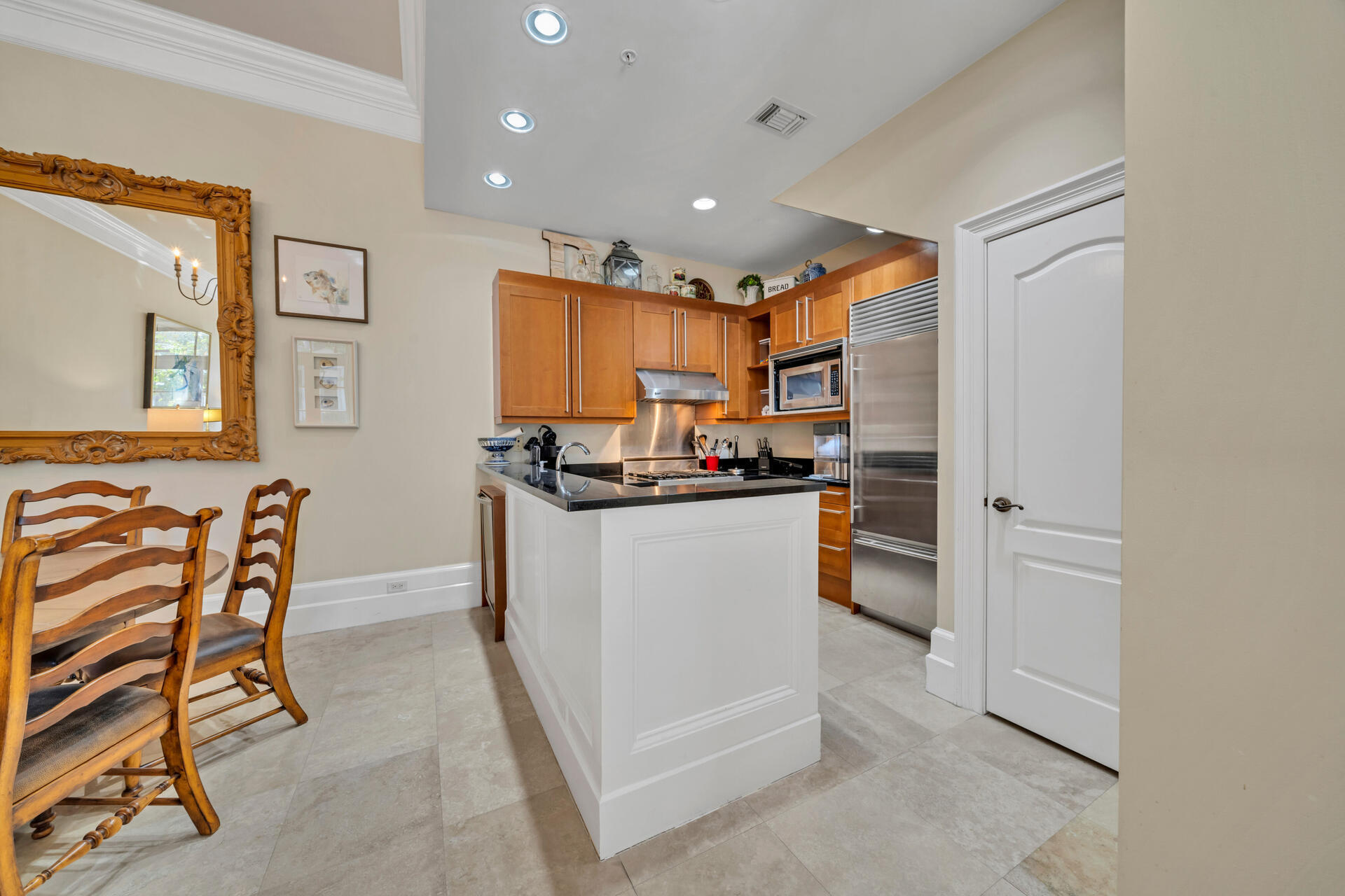 9201 Market Street Inn, Unit 162 Miramar Beach, FL 32550 - Photo 25 of 67 a kitchen with stainless steel appliances kitchen island granite countertop a refrigerator and a stove top oven