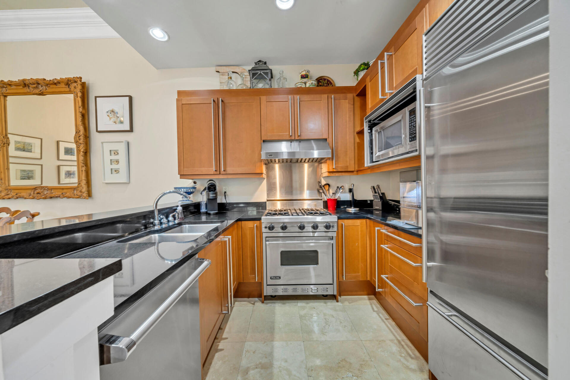 9201 Market Street Inn, Unit 162 Miramar Beach, FL 32550 - Photo 27 of 67 a kitchen with stainless steel appliances granite countertop a stove and a refrigerator