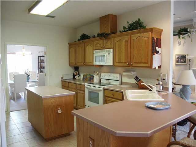 2585 Crescent Road Navarre, FL 32566 - Photo 4 of 7 a kitchen with a sink appliances and cabinets