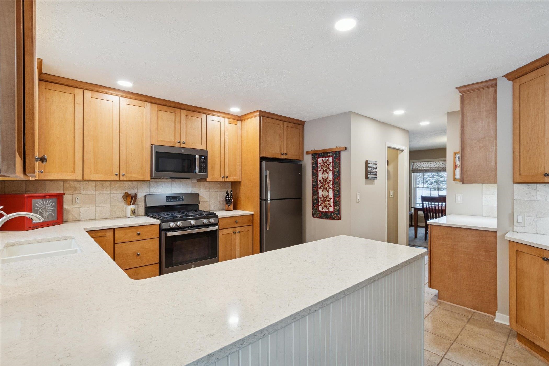 10906 Hamborg Road Roscoe, IL 61073 - Photo 15 of 65 a kitchen with stainless steel appliances granite countertop a refrigerator stove microwave and sink