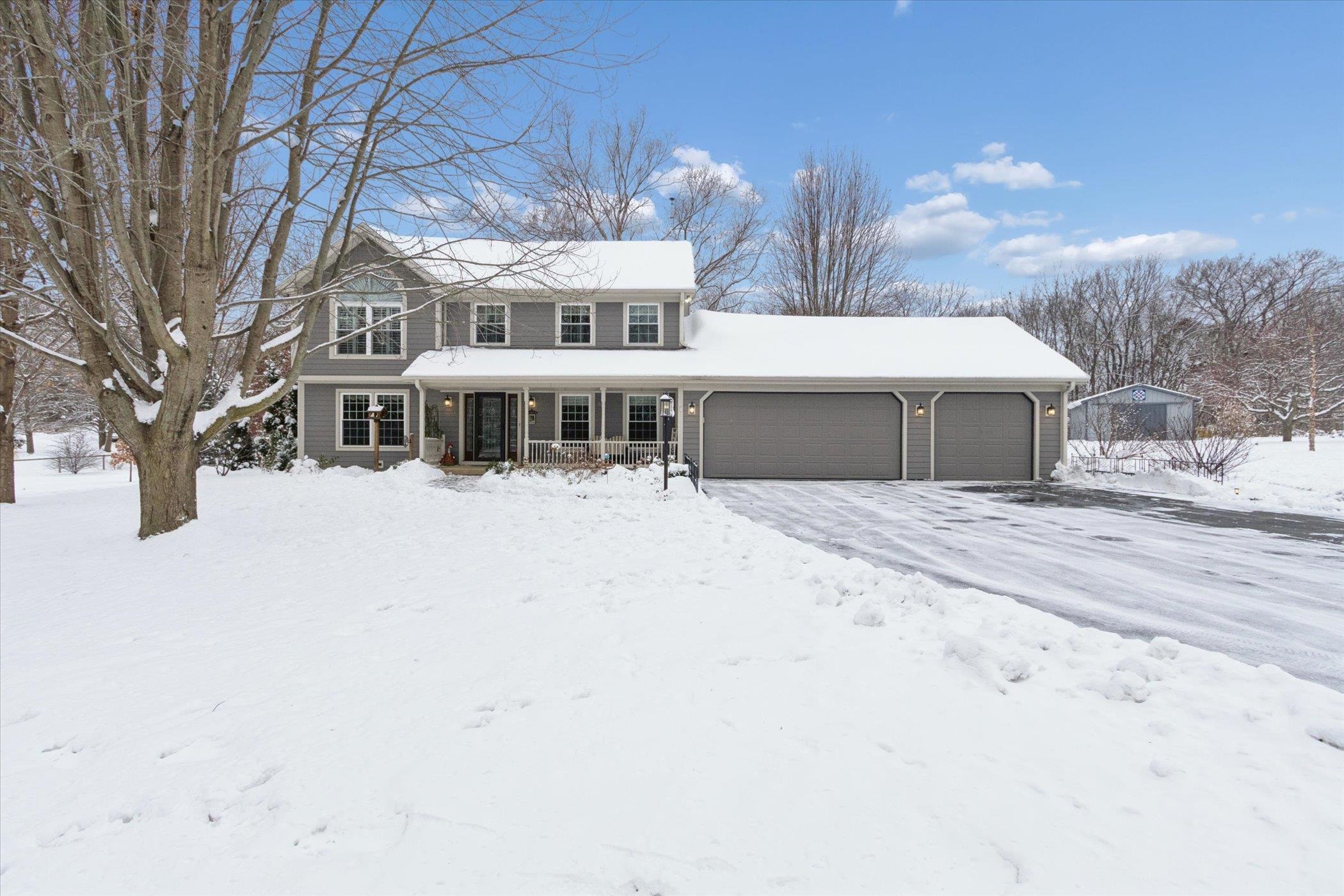 10906 Hamborg Road Roscoe, IL 61073 - Photo 2 of 65 a view of a white house with a yard covered in snow