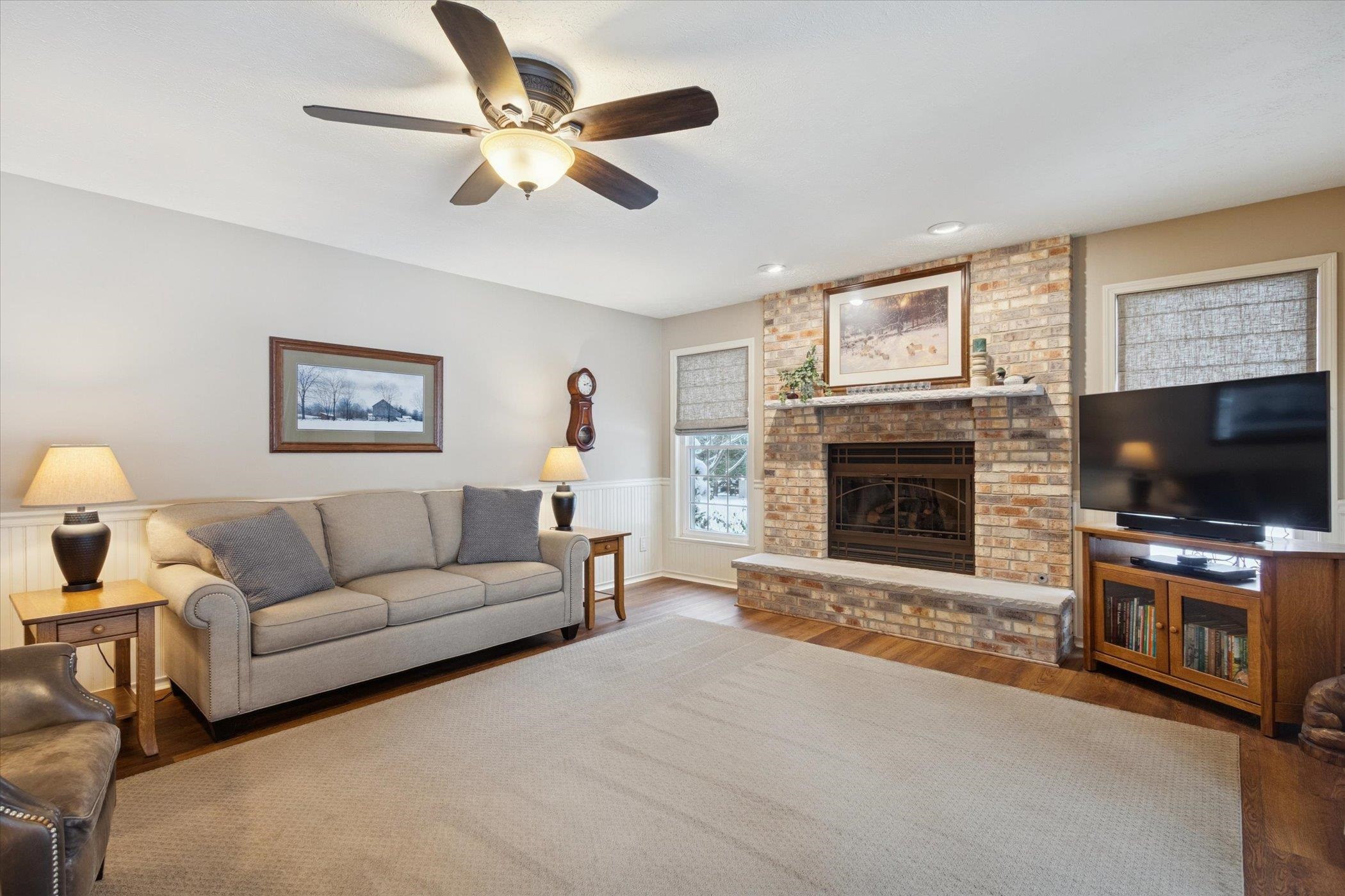 10906 Hamborg Road Roscoe, IL 61073 - Photo 22 of 65 a living room with furniture a flat screen tv and a fireplace