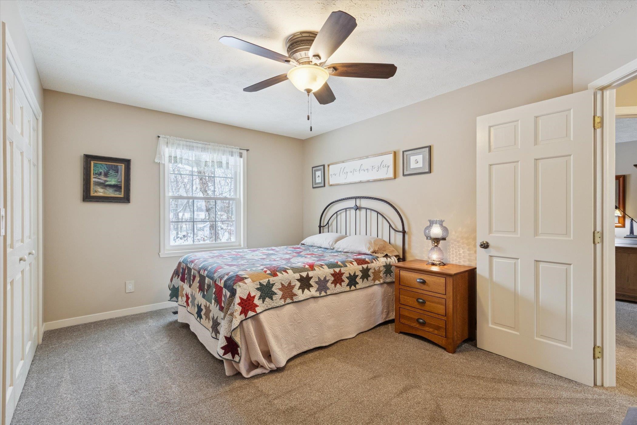 10906 Hamborg Road Roscoe, IL 61073 - Photo 27 of 65 a bedroom with a bed and a ceiling fan