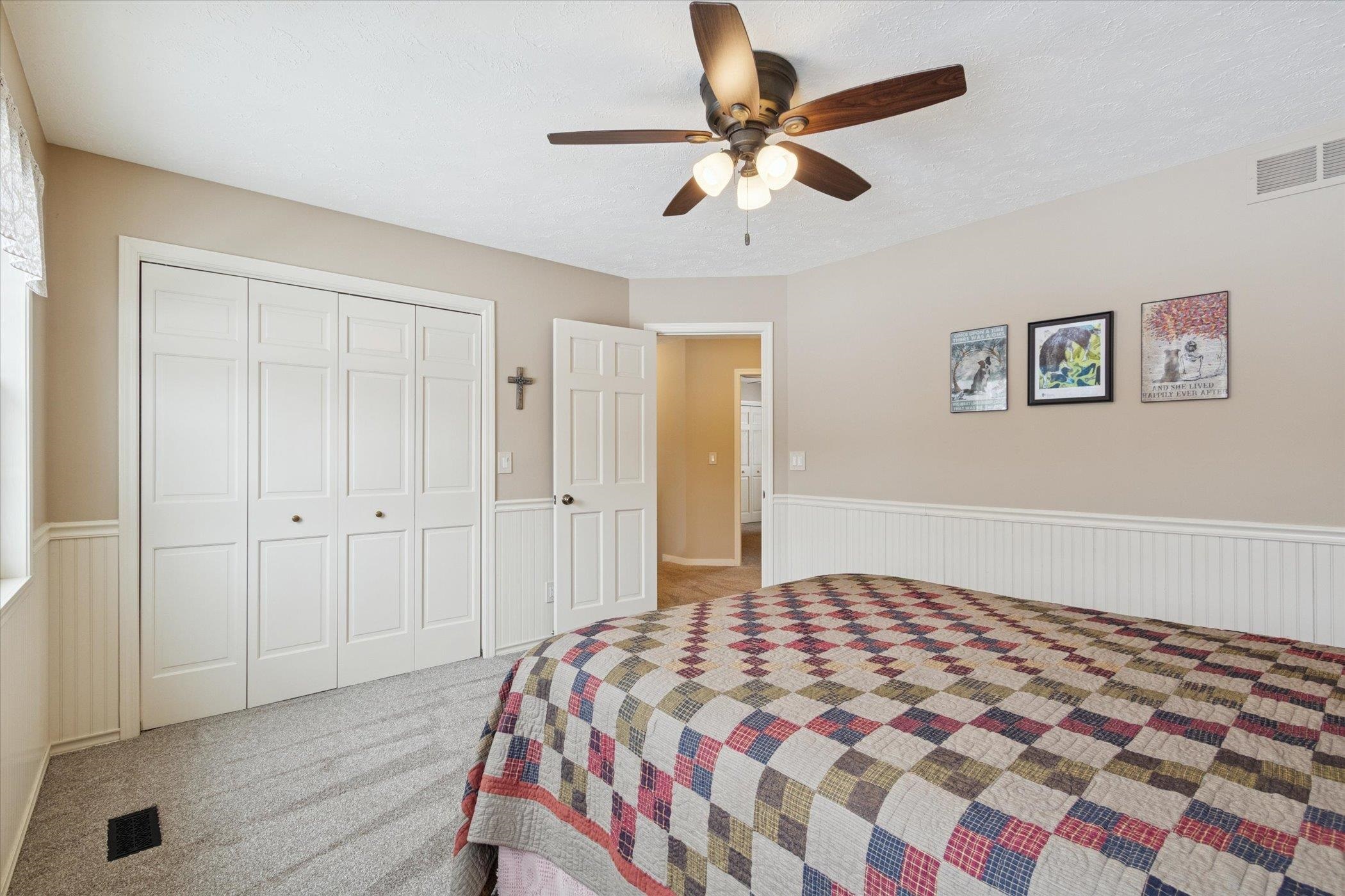 10906 Hamborg Road Roscoe, IL 61073 - Photo 32 of 65 a bedroom with a bed and a chandelier