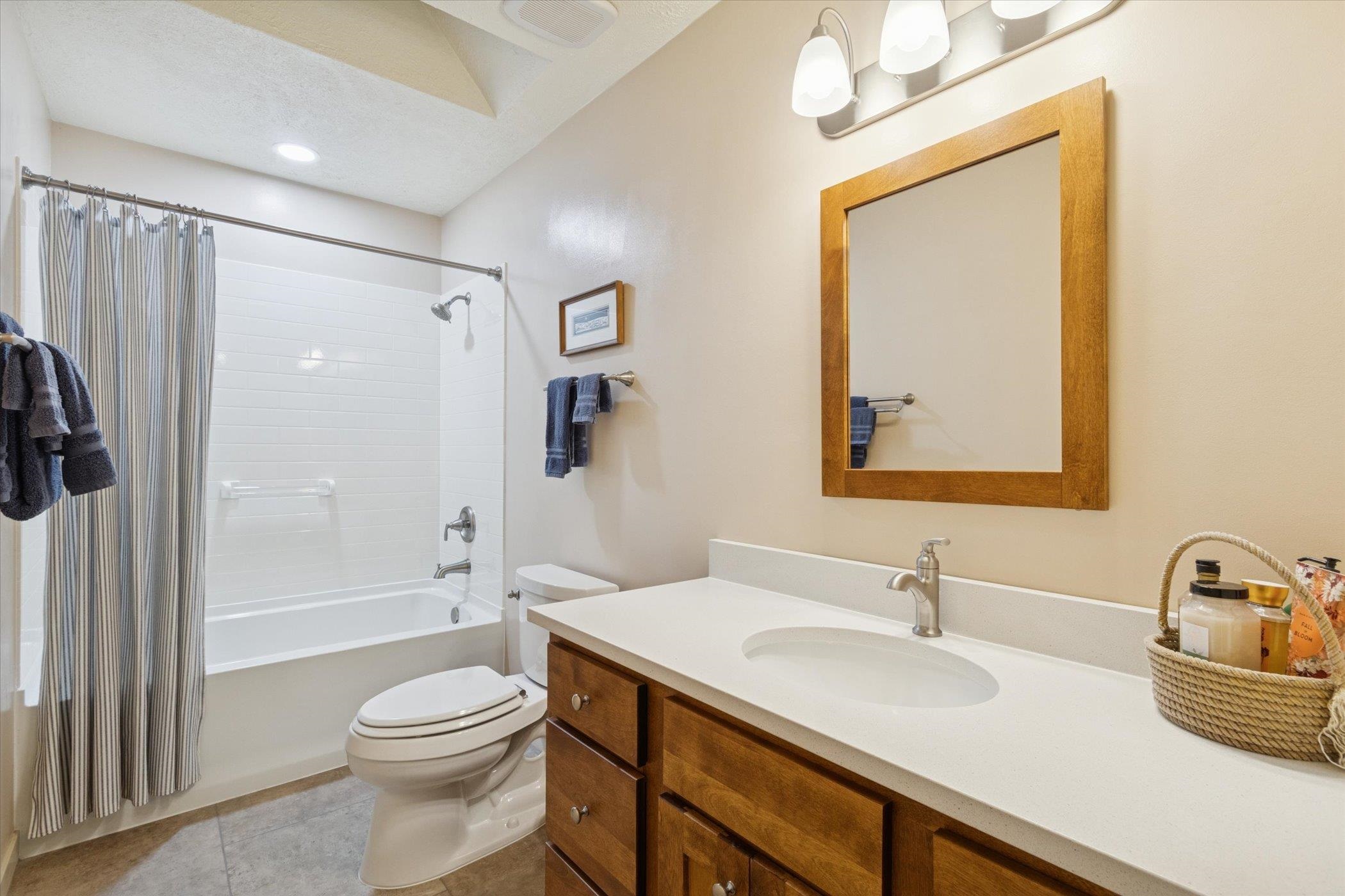 10906 Hamborg Road Roscoe, IL 61073 - Photo 33 of 65 a bathroom with a granite countertop sink a toilet and shower