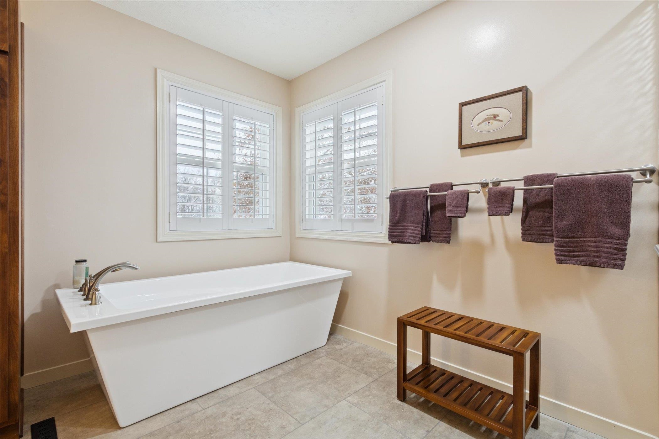 10906 Hamborg Road Roscoe, IL 61073 - Photo 38 of 65 a bathroom with a bathtub and window