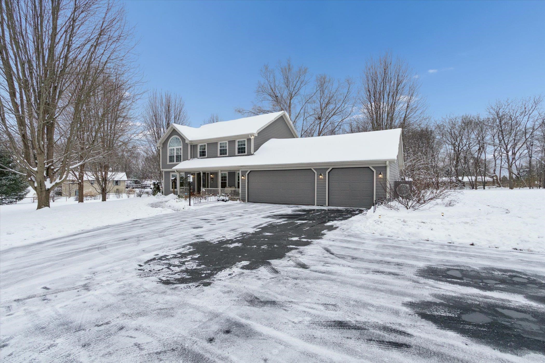 10906 Hamborg Road Roscoe, IL 61073 - Photo 5 of 65 a front view of a house with a yard and garage