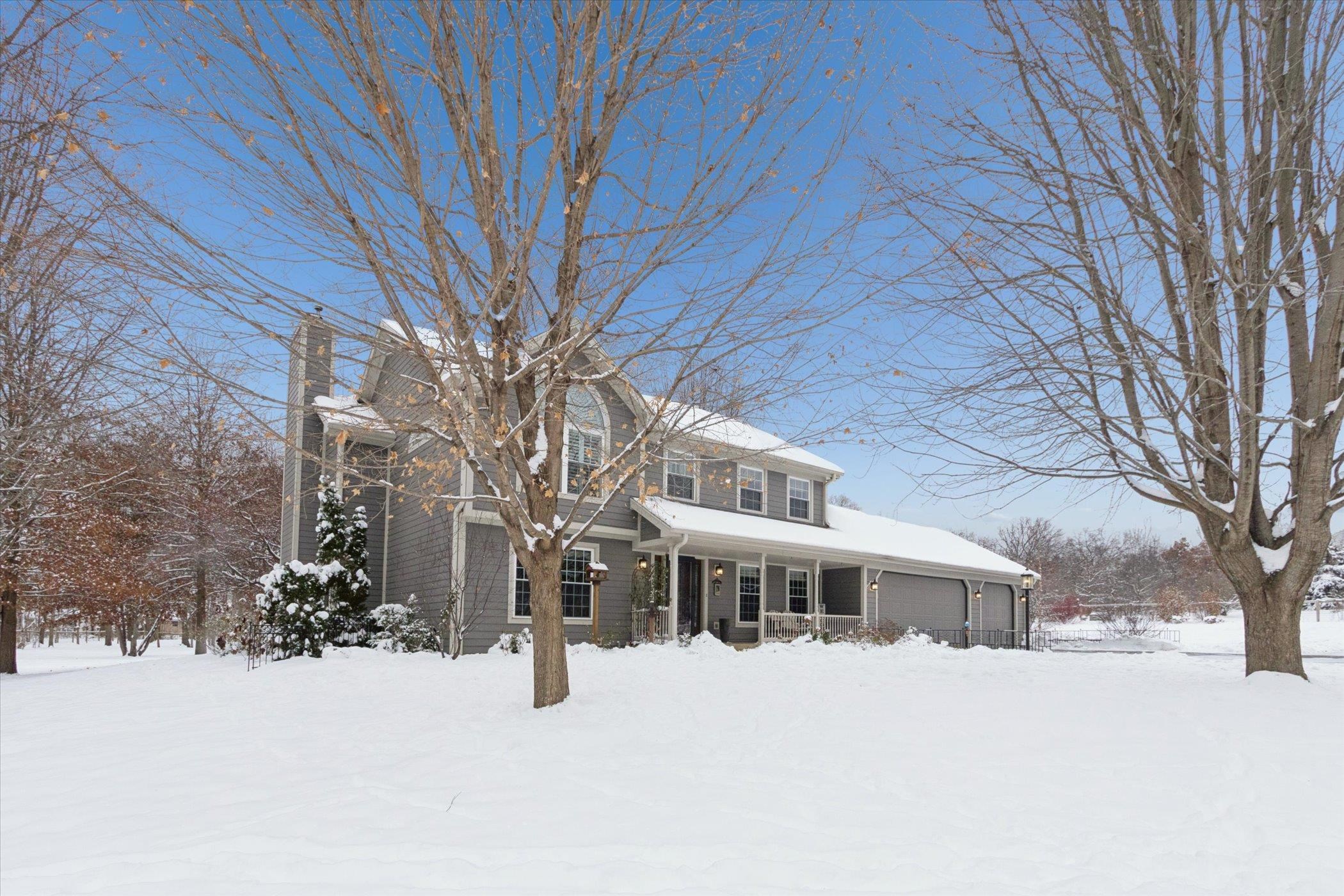 10906 Hamborg Road Roscoe, IL 61073 - Photo 6 of 65 a front view of a house with a yard covered in snow