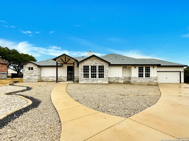 a front view of a house with yard and patio