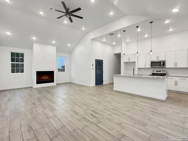 a view of kitchen with kitchen island microwave and stove