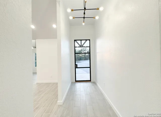 an empty room with cabinet and wooden floor