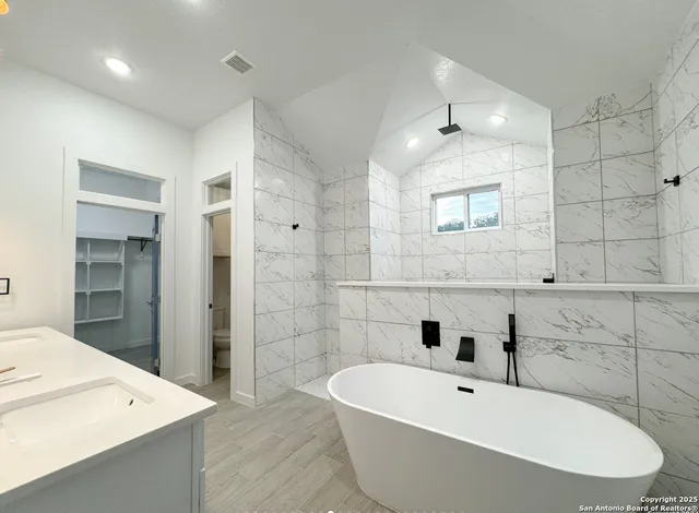 a bathroom with a bathtub and a sink