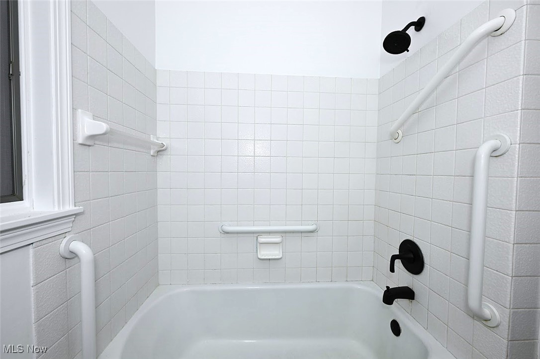 351 North Messner Road Akron, OH 44319 - Photo 28 of 44 *BATHROOM W/WHITE VANITY, LINEN CLOSET, BLACK ACCENT HARDWARE AND PFISTER FAUCET, MIRROR AND DOUBLE LIGHTING SCONCE, TUB AND SHOWER, LUXURY PLANK FLOORING ~