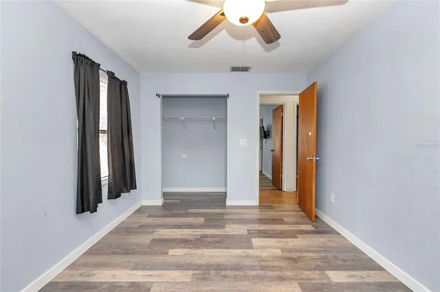 a view of a hallway with a chandelier fan and a window