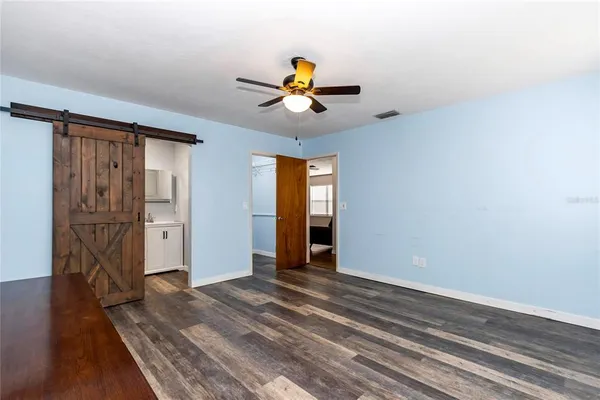 a view of empty room with wooden floor