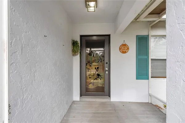 a view of a hallway with entryway door