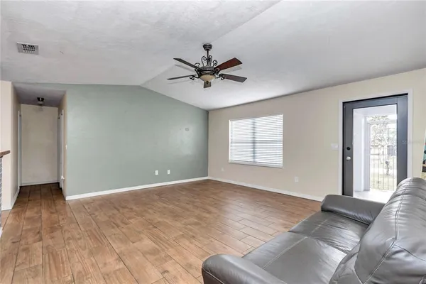 a living room with furniture and a ceiling fan