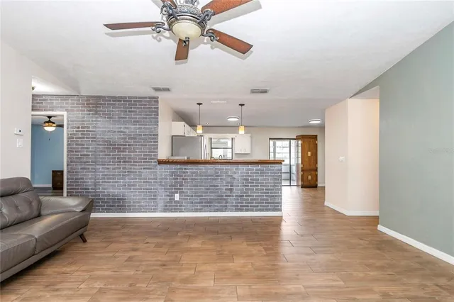 a view of livingroom with hardwood floor and ceiling fan