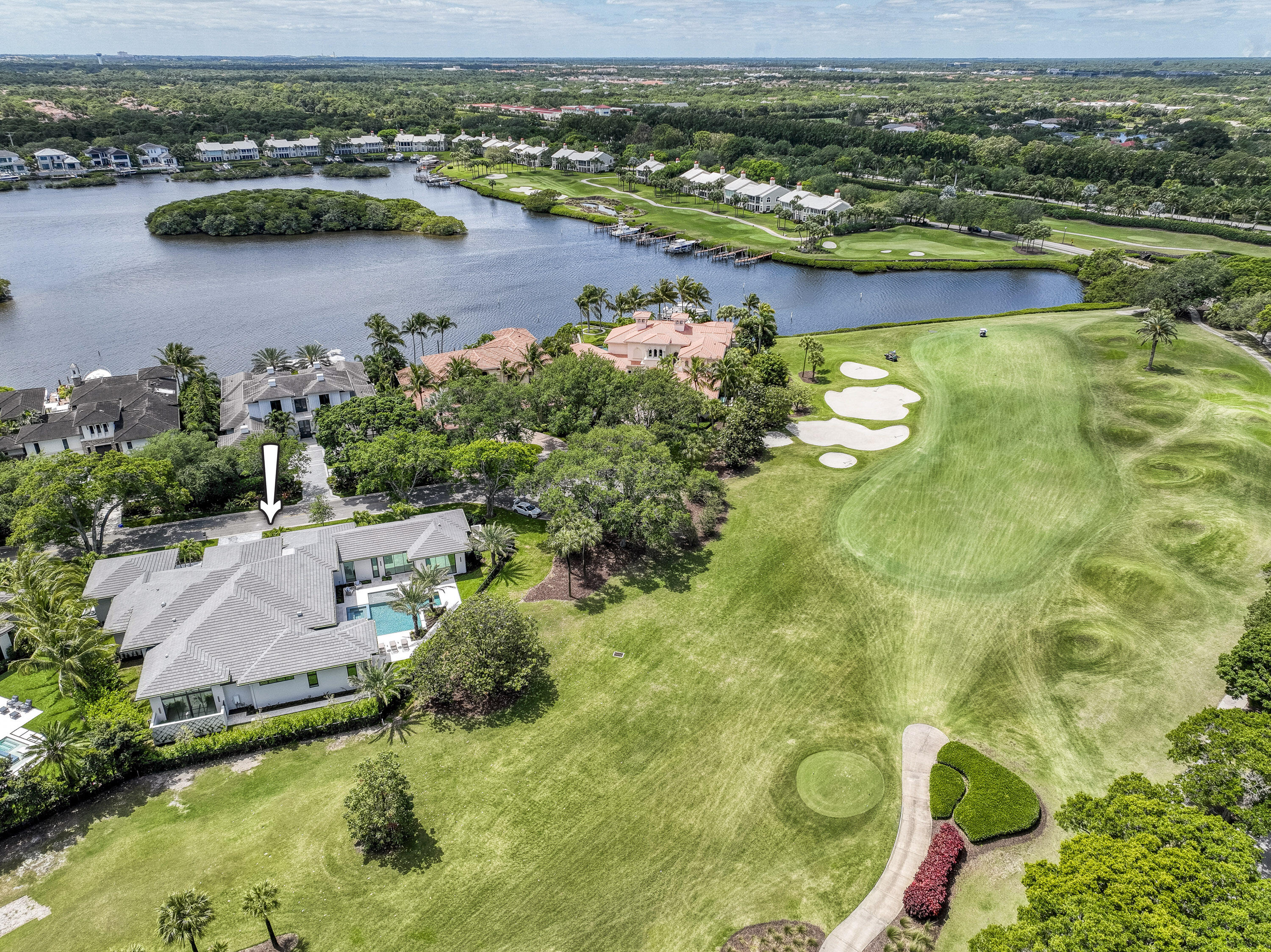 an aerial view of residential houses with outdoor space and lake view