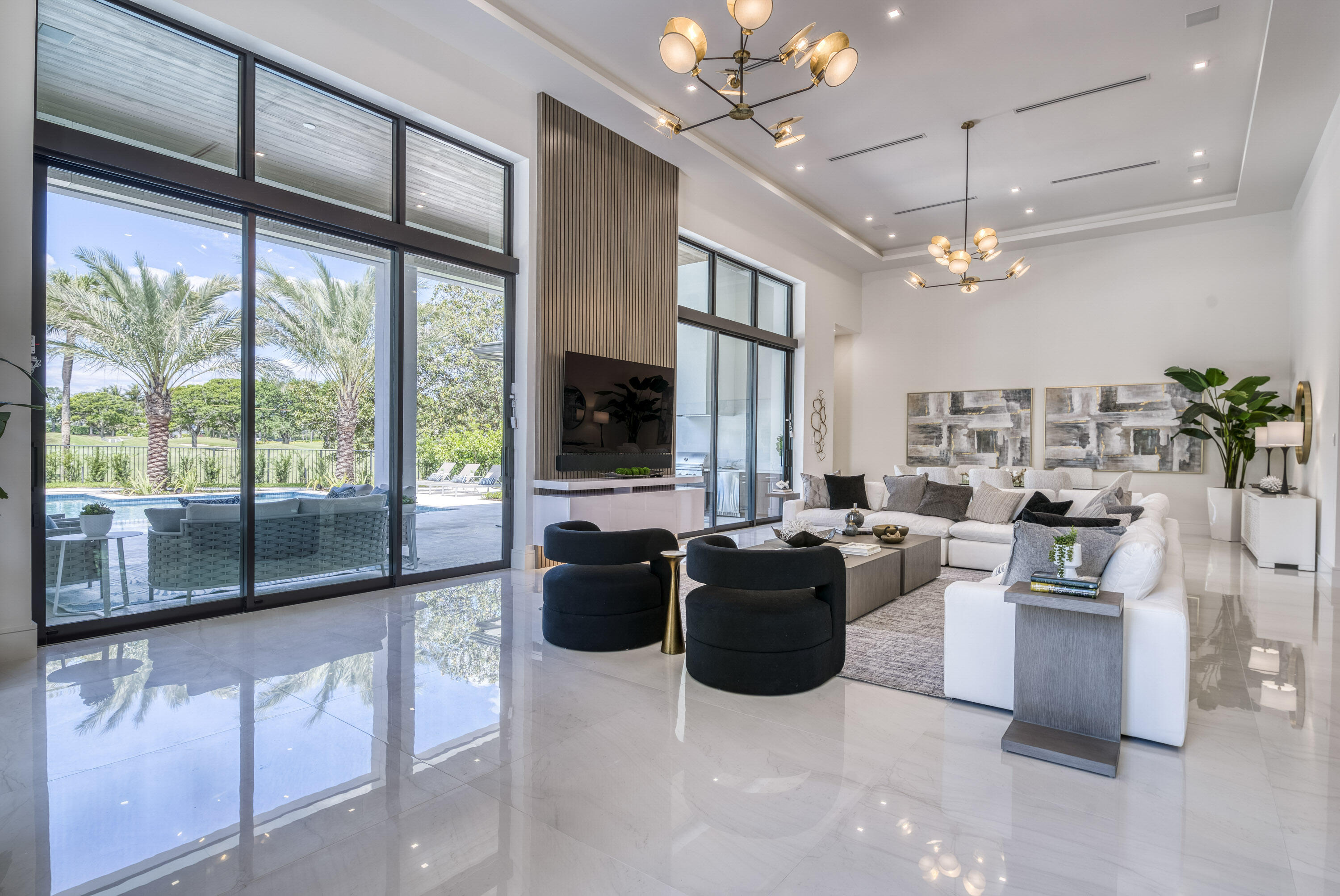 119 Clipper Lane Jupiter, FL 33477 - Photo 12 of 63 a living room with furniture a chandelier and a flat screen tv
