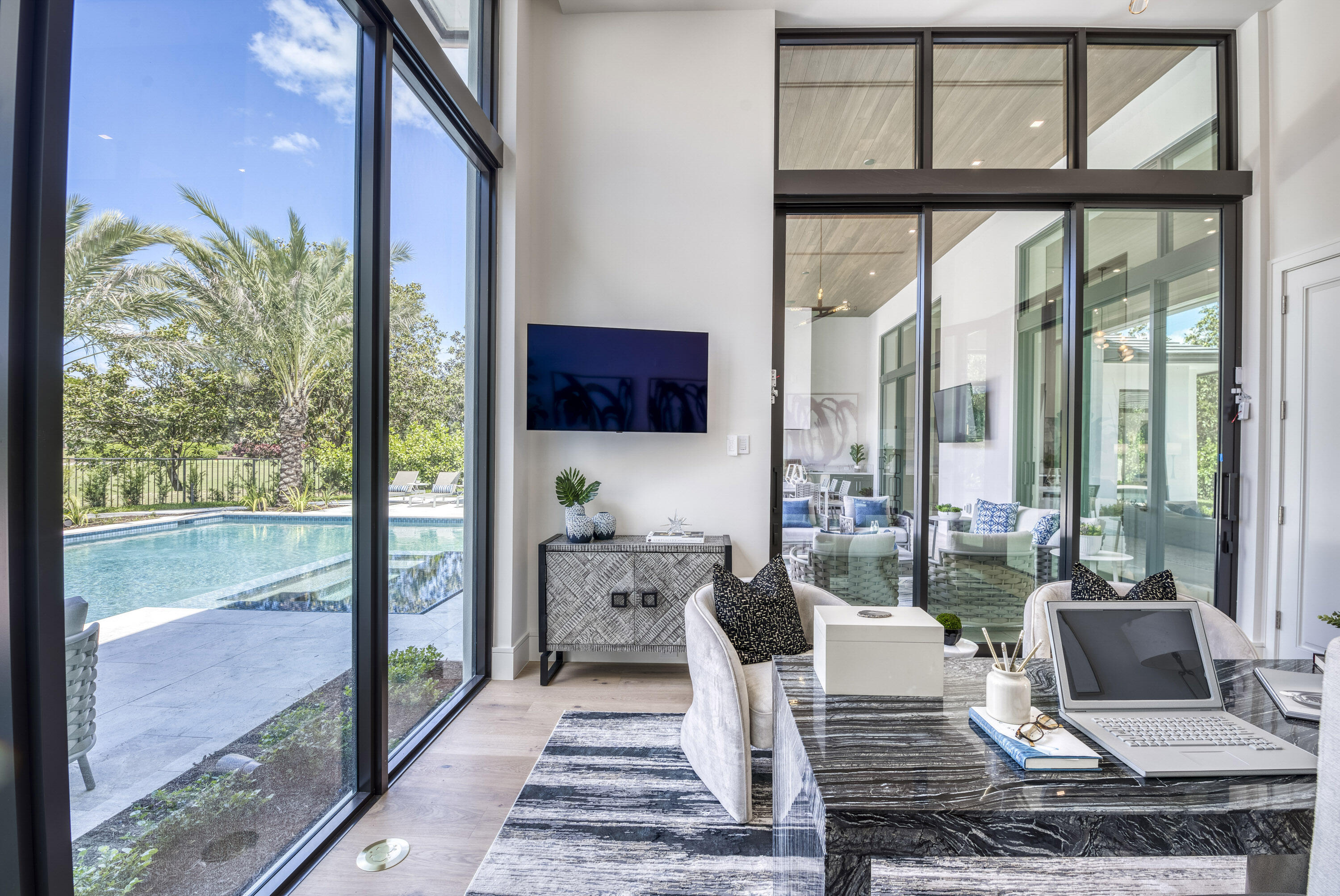 119 Clipper Lane Jupiter, FL 33477 - Photo 34 of 63 a view of an empty room with floor to ceiling windows and wooden floor