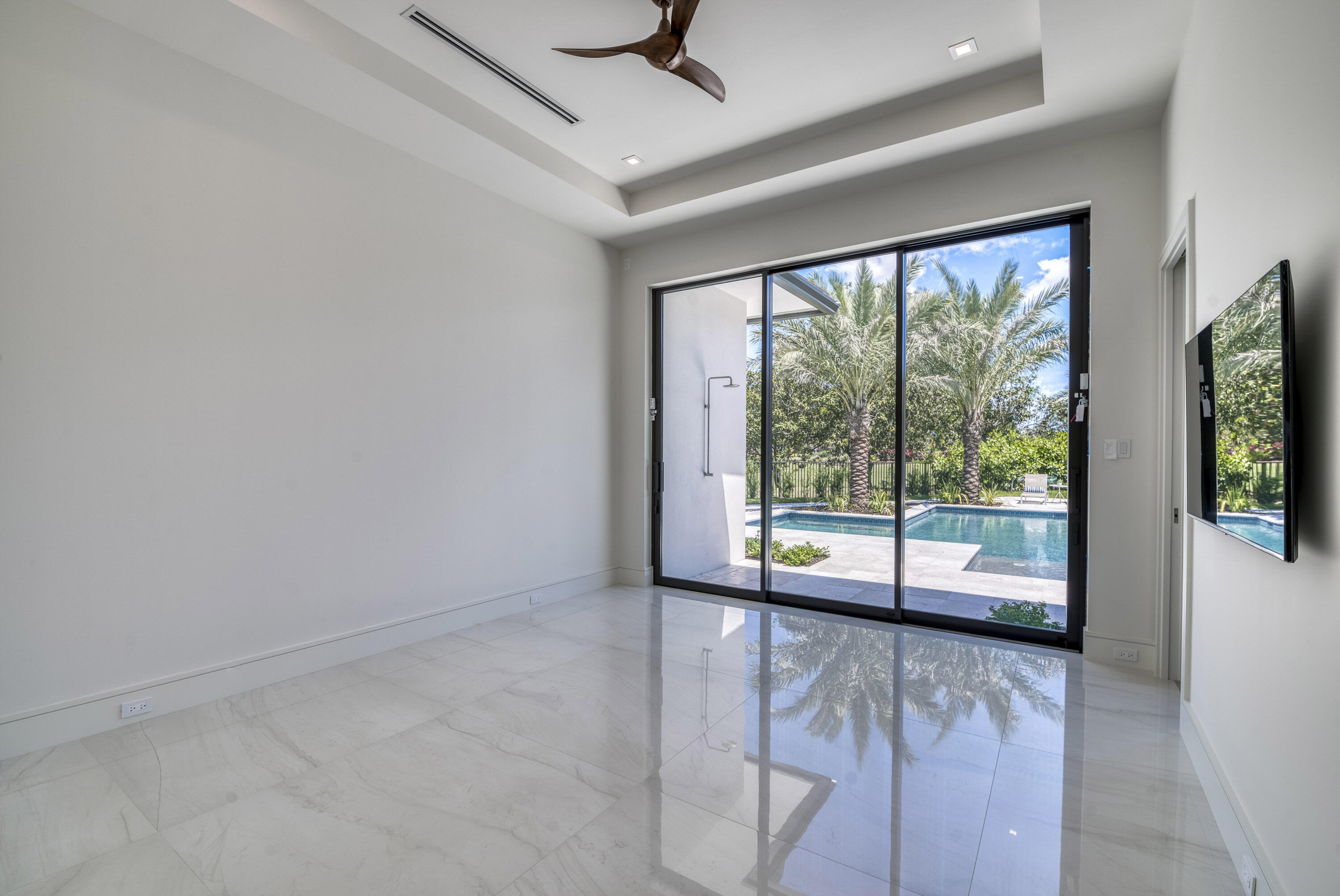 119 Clipper Lane Jupiter, FL 33477 - Photo 41 of 63 a view of an empty room with wooden floor and windows