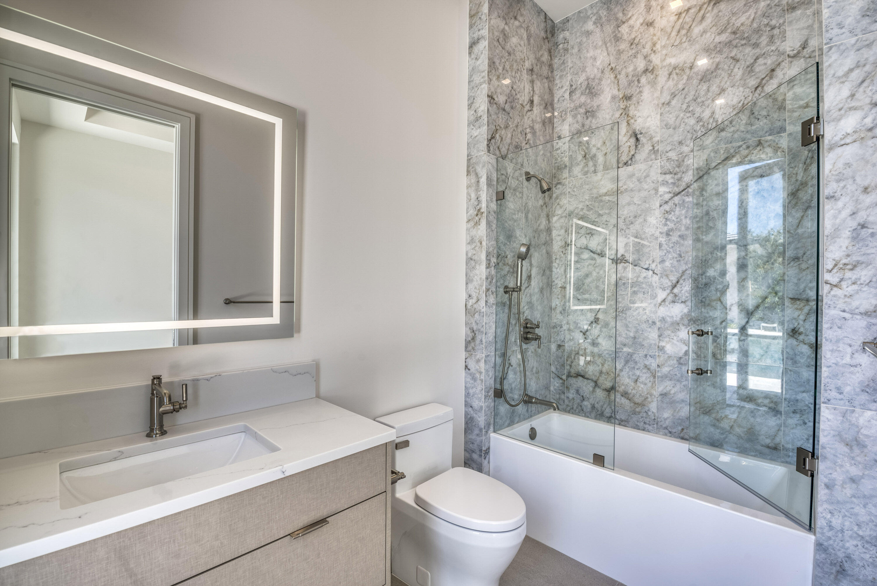 119 Clipper Lane Jupiter, FL 33477 - Photo 42 of 63 a bathroom with a bathtub shower sink vanity mirror and toilet