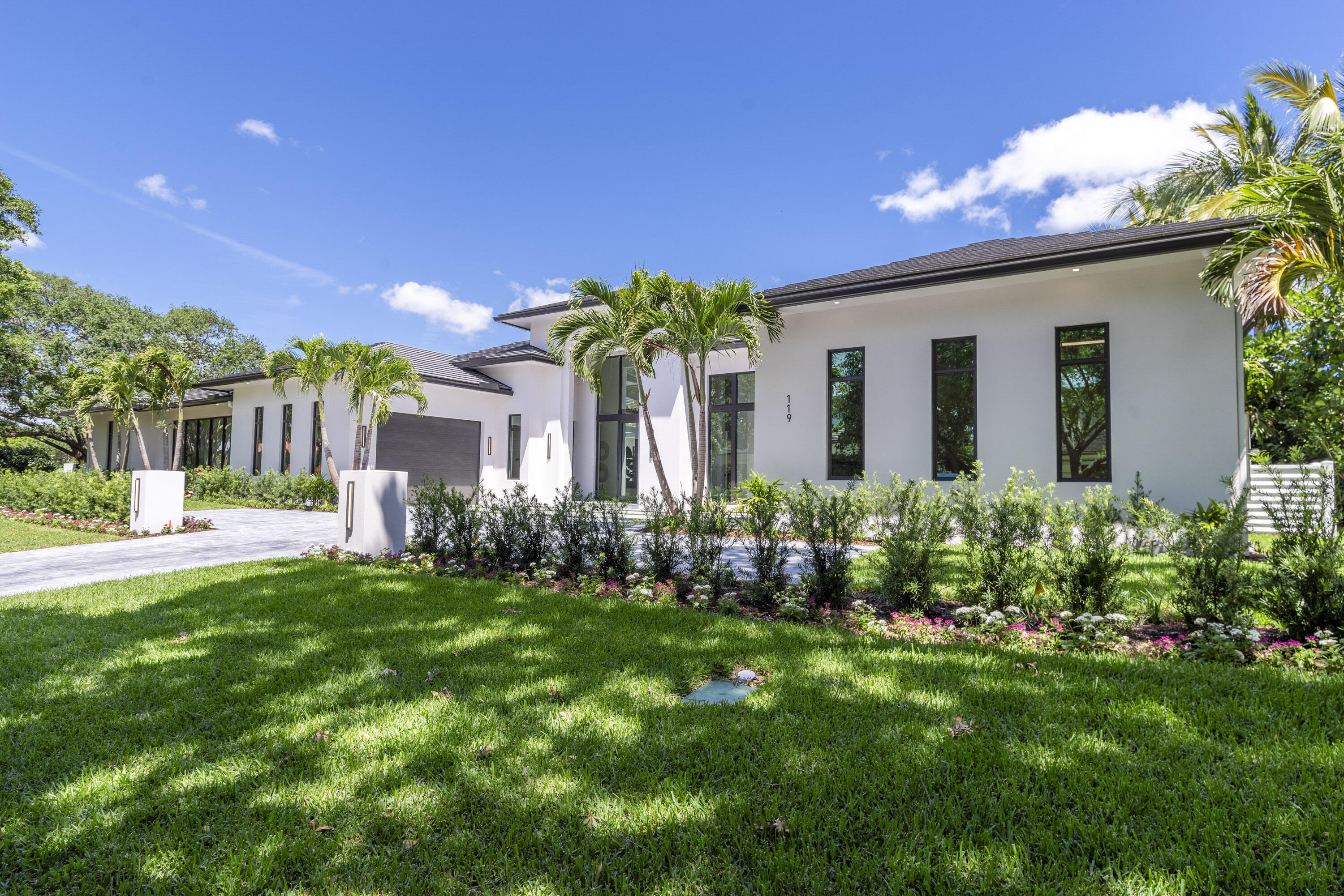 119 Clipper Lane Jupiter, FL 33477 - Photo 5 of 63 a front view of a house with a yard