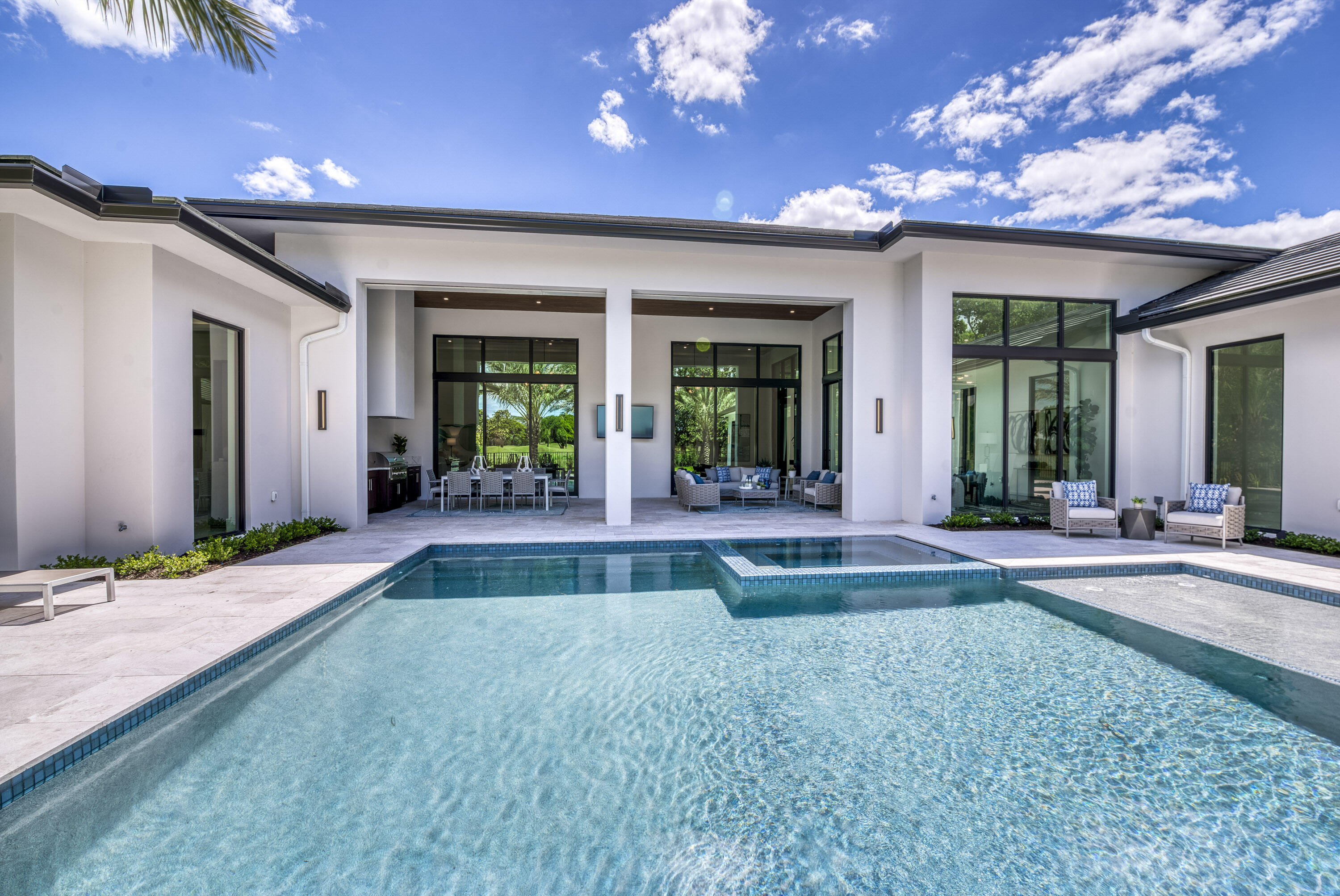 119 Clipper Lane Jupiter, FL 33477 - Photo 56 of 63 a view of a house with a swimming pool and porch with furniture