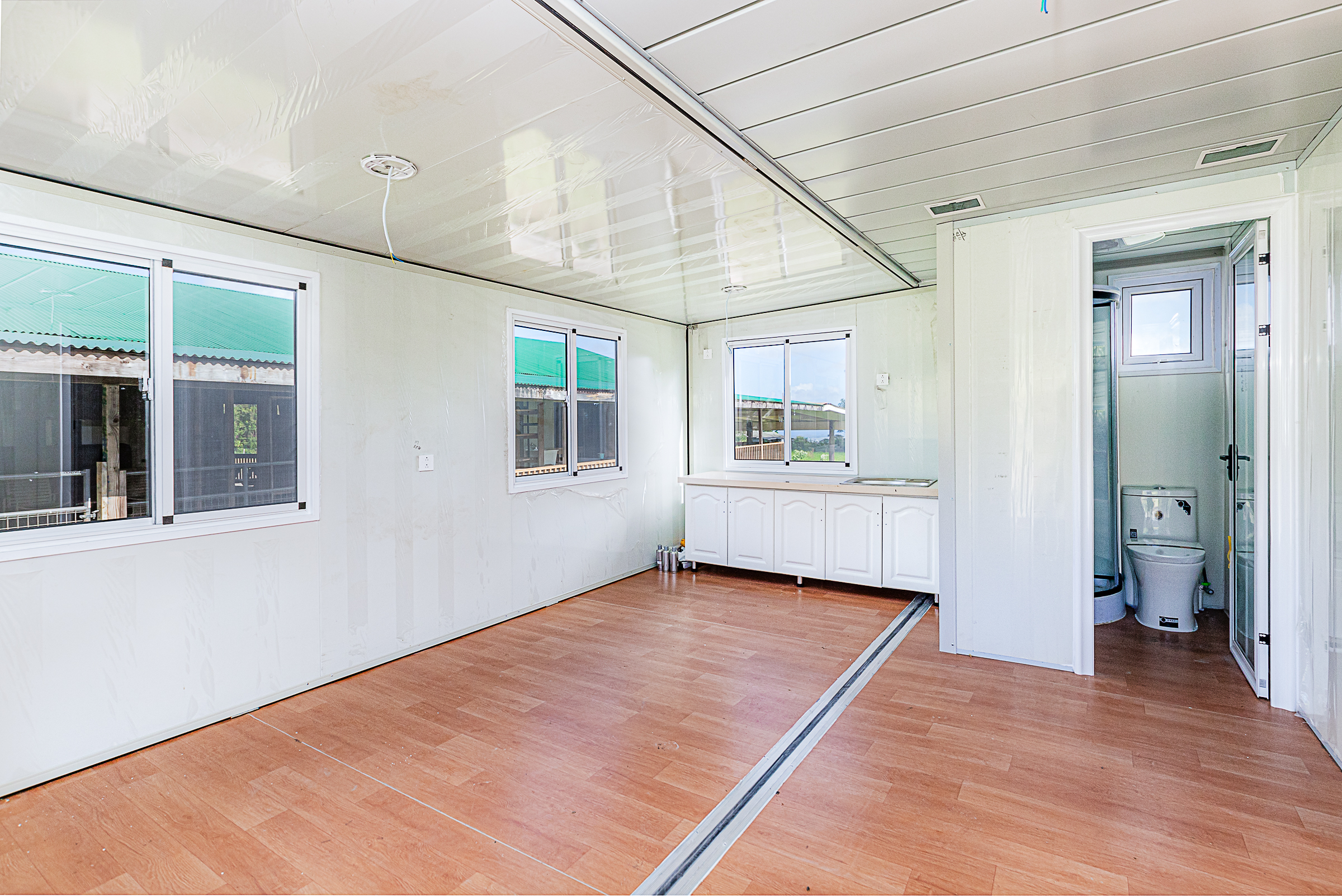 681 Hoaka Road Hilo, HI 96720 - Photo 21 of 26 a view of an empty room with wooden floor and a window