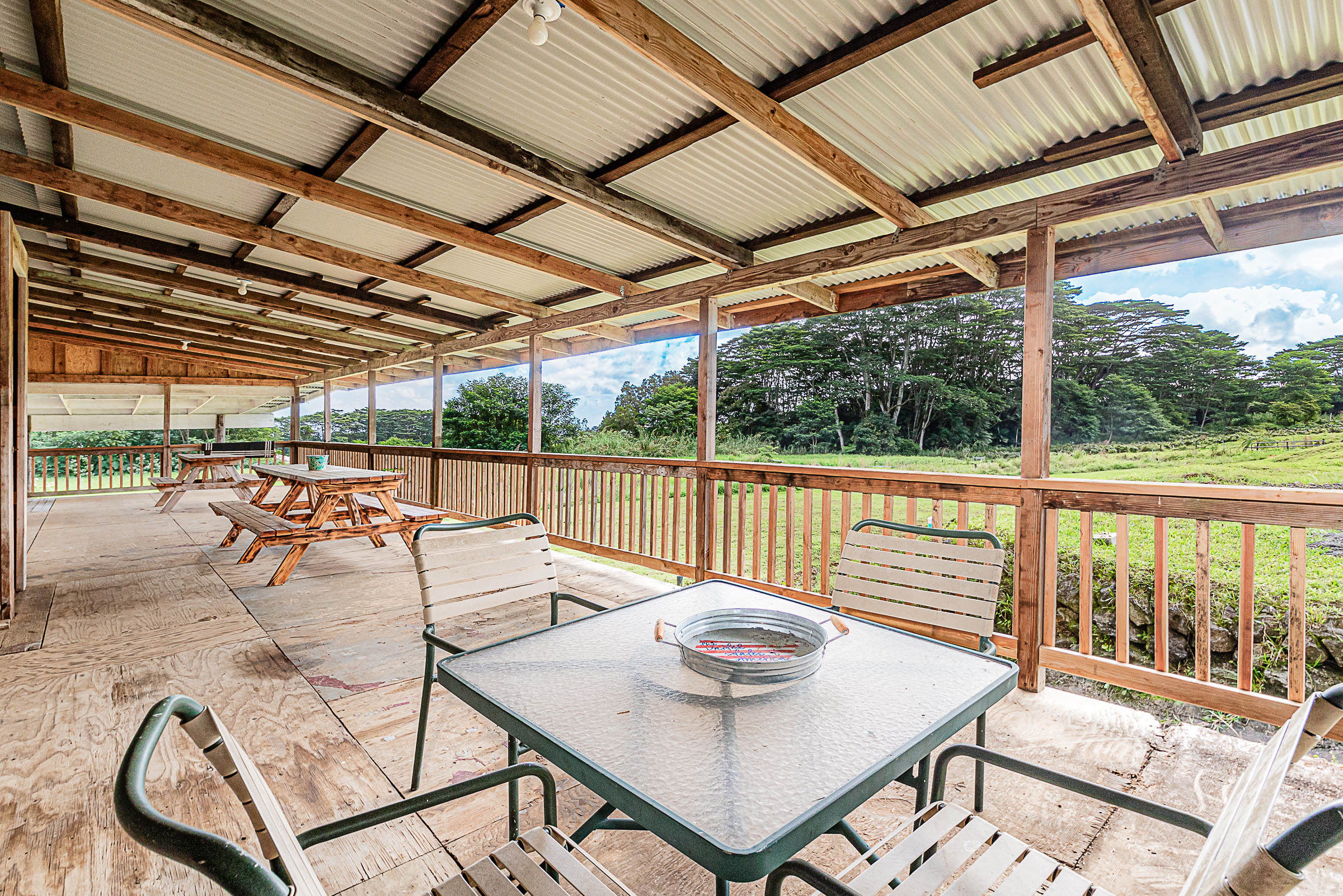681 Hoaka Road Hilo, HI 96720 - Photo 4 of 26 a view of a patio with a dining table and chairs