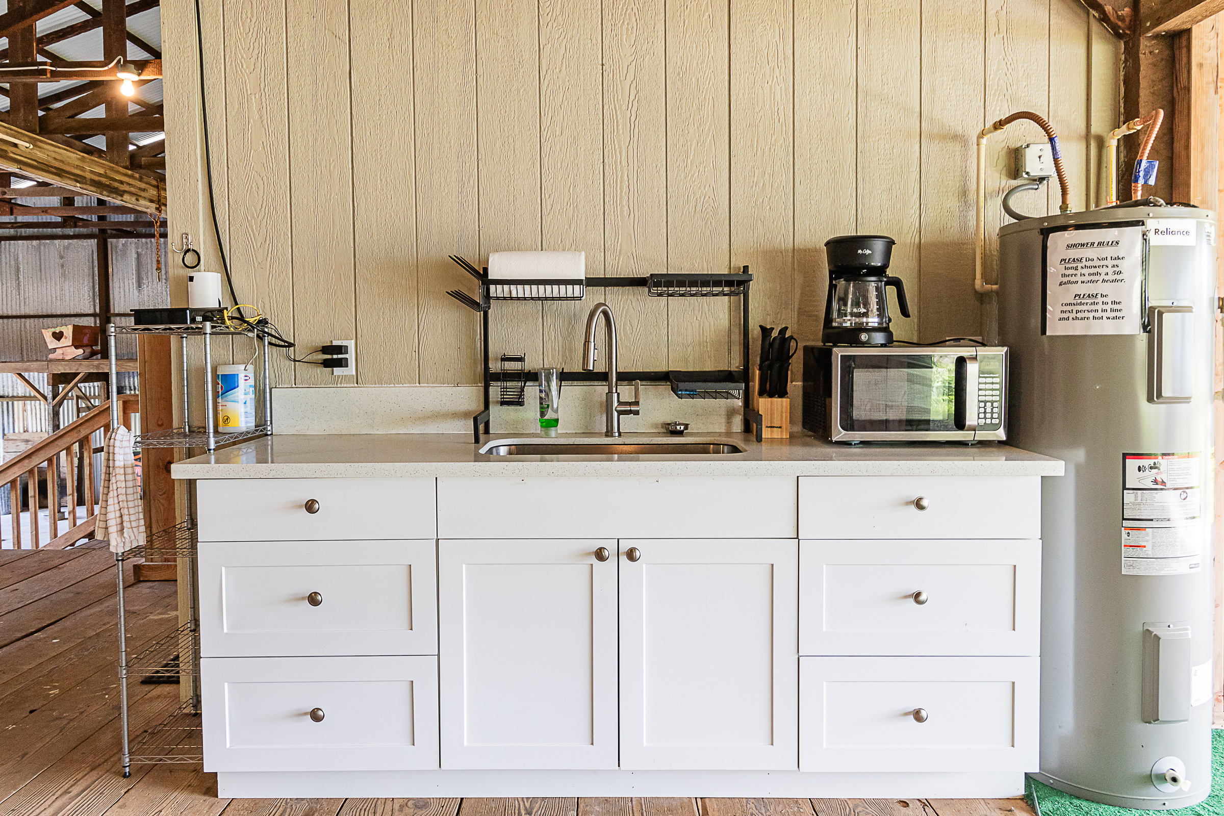 681 Hoaka Road Hilo, HI 96720 - Photo 7 of 26 a kitchen with stainless steel appliances white cabinets and a refrigerator